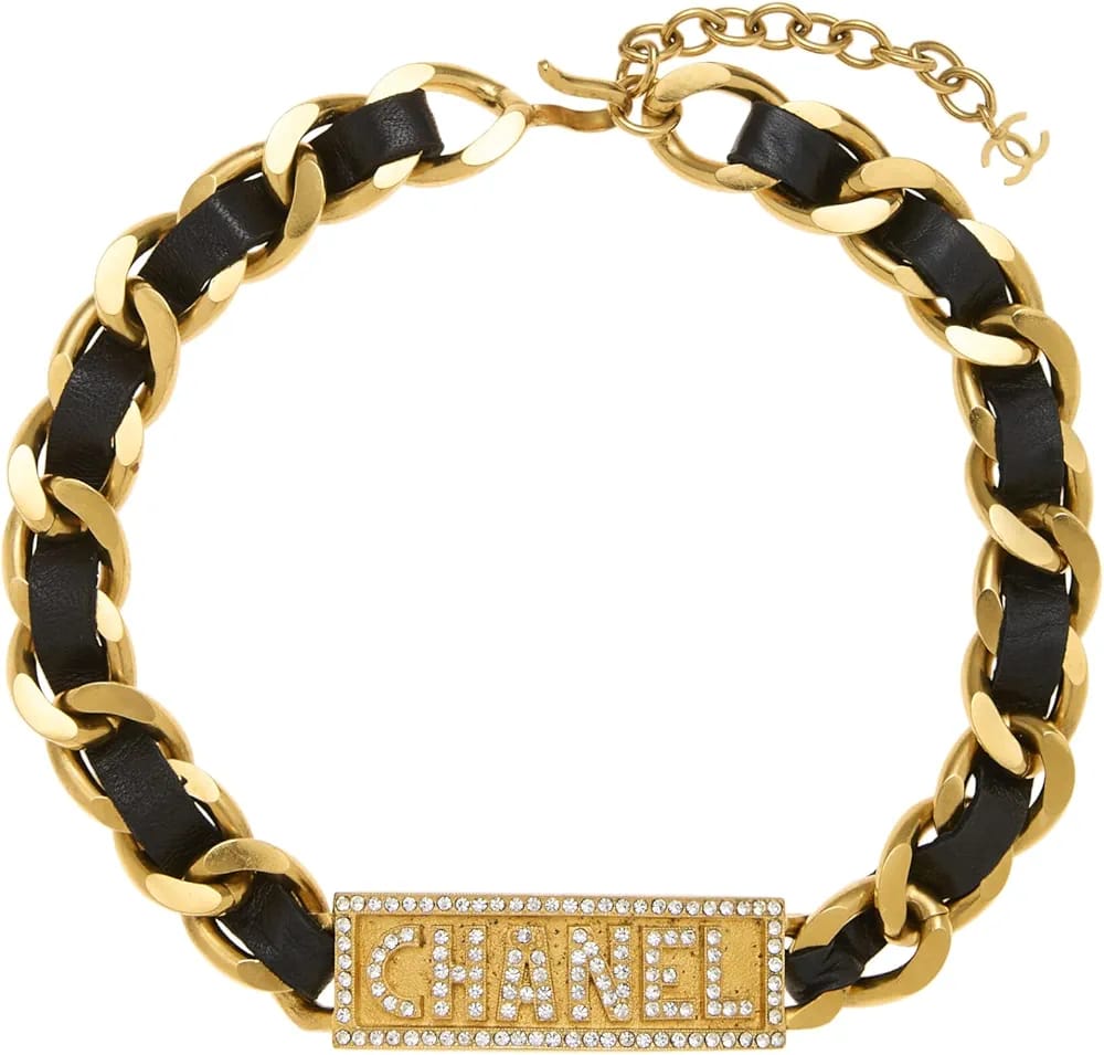 Authentic Chanel pre-loved black and gold crystal logo choker in timeless luxury design